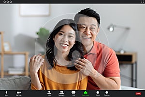 Cheerful korean couple having video conference with friends, screenshot photo