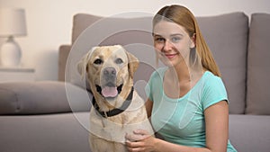 Cheerful labrador retriever dog female owner smiling to camera pet companionship