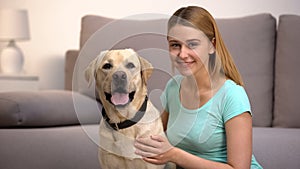 Cheerful labrador retriever dog female owner smiling to camera pet companionship