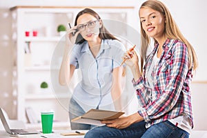 Cheerful ladies working in office