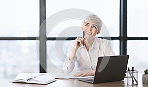 Cheerful Lady At Laptop Dreaming Sitting At Workplace In Office