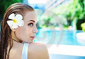 Cheerful lady relaxing by the hotel`s swimming - pool