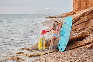 Cheerful lady on summer holiday. Surfing in ocean, sense of adventure and relaxation time on nature concept. Copy space