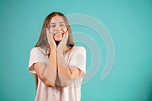 Cheerful likeable young woman in white T-shirt with happy dreaming look