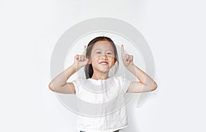 Cheerful little Asian child girl raised two forefinger to cheer isolated on white background. Cheerful emotion concept