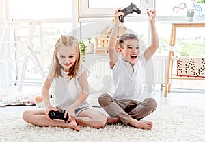 Little boy and girl playing video game