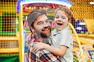 Cheerful little boy having fun with his dad