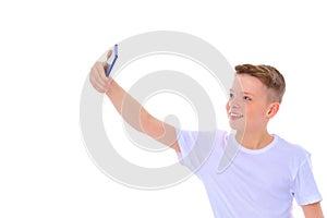 A cheerful little boy is making a selfie.