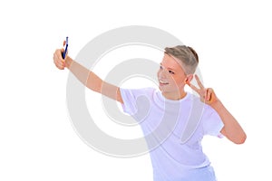 A cheerful little boy is making a selfie.