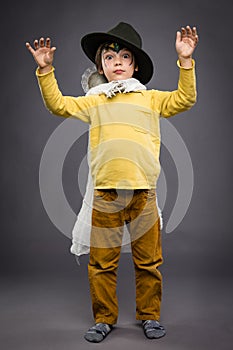 Cheerful little boy with spook, Halloween celebration