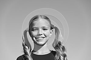 Cheerful little girl adorable ponytails hairstyle outdoors, true happiness concept