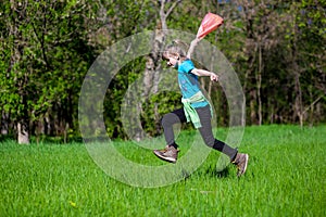 Cheerful little girl jump on the grass