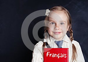 Cheerful little girl learning french. Learning french language