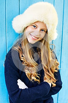 Cheerful little girl in warm sweater.