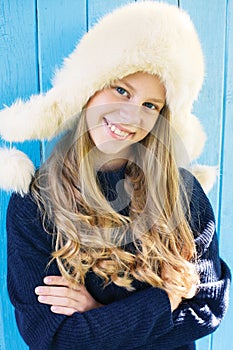 Cheerful little girl in warm sweater.