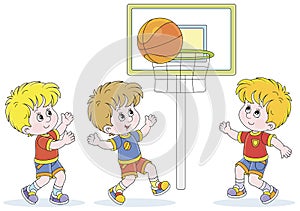 Cheerful little kids playing basketball