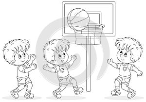 Cheerful little kids playing basketball