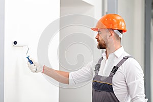 Cheerful male builder is making house beautiful