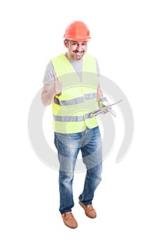 Cheerful male builder with tablet thumb up