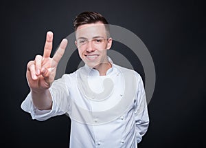 Cheerful male cook taking two orders