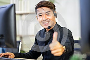 Cheerful male customer service operator showing thumbs up in office. Service Mind