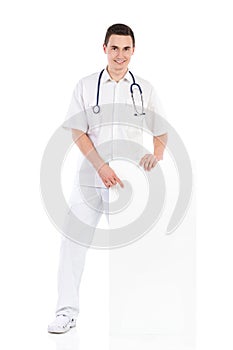 Cheerful male doctor pointing at a blank placard