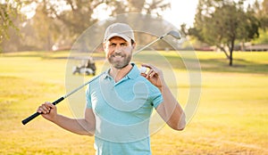 cheerful male golf player on professional course with green grass hold ball, sport