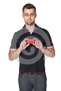 Cheerful male showing red card in hand