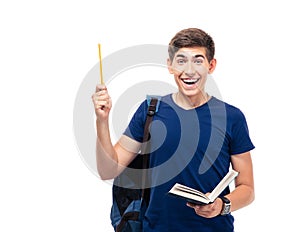 Cheerful male student holding book and pencil