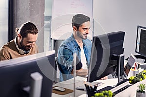 Cheerful male typing on notebook computer keyboard