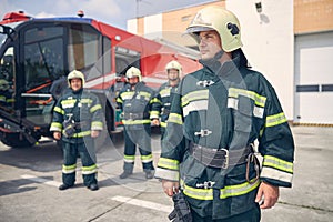 Cheerful male wearing protective uniform and helmet