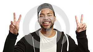 Cheerful man with braces giving double peace sign happily