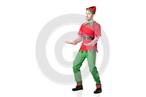 cheerful man in christmas elf costume outstreching hands in excitement isolated