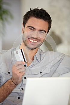 Cheerful man with credit card