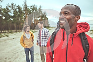 Cheerful man enjoying his journey with friends