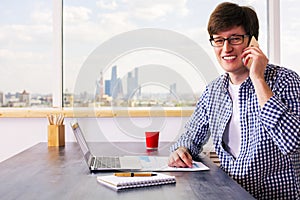 Cheerful man having phone conversation