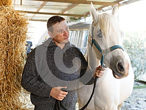 Cheerful man horse farm worker