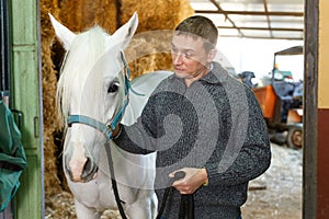 Cheerful man horse farm worker