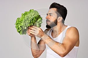 Cheerful man lettuce leaves healthy food posing