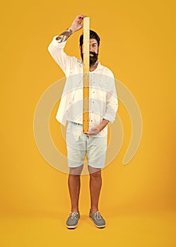 cheerful man with measuring ruler on background. photo of man with measuring ruler.