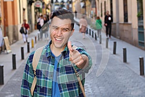 Cheerful man pointing at camera outdoors