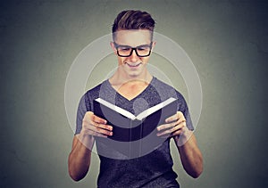 Cheerful man reading a book