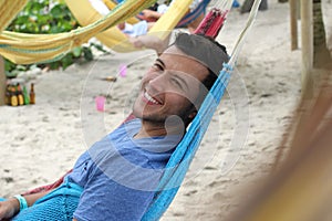 Cheerful man resting in a hammock