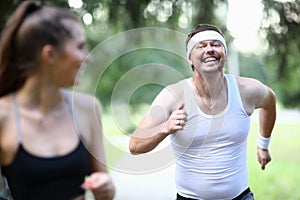 Cheerful man running in park photo