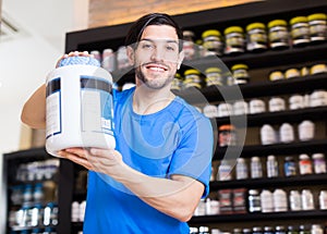 Cheerful man seller demostration sport products photo