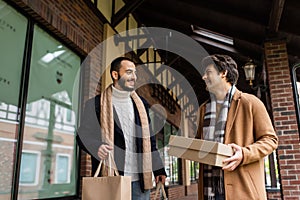 cheerful man with shoebox looking at