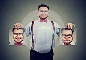 Cheerful man showing different photos with emotions