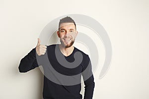 Cheerful man showing like, thumb-up gesture