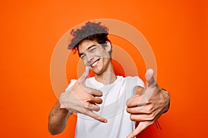 Cheerful man white t-shirt gestures with hand emotions fashion