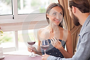 Cheerful man and woman are resting in cafe